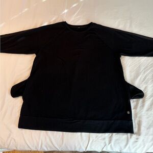 Black crew neck sweatshirt with pockets.